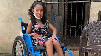 Young Girl smiling, sitting in a wheelchair