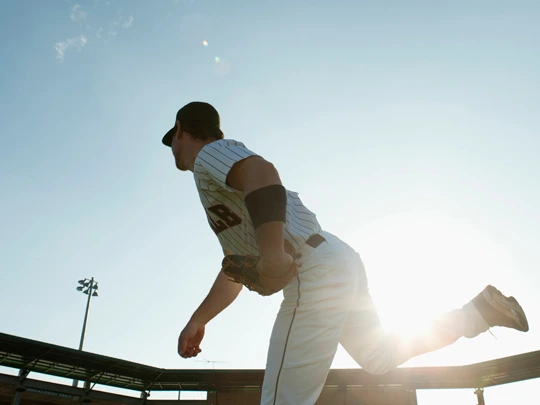 SAM-Athletes_Entertainment-For_professionals-153350012 Baseball pitcher in white Uniform and blue cap practicing. - For professional athletes